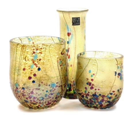 Three Isle of Wight glass 'Summer Fruits' vases, designed by Timothy and Jonathan Harris, comprising cylindrical vase bearing paper label, 13cm high, and two vases of compressed form, 10cm high and 7.5cm high, goldberry colourway, unsigned, all boxed.