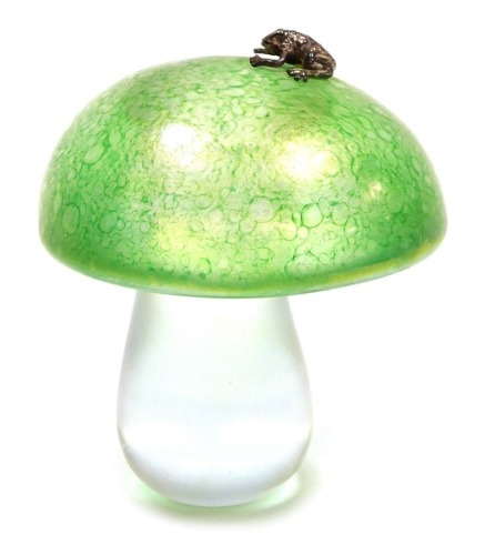 A green iridescent glass mushroom paperweight, possibly by John Ditchfield, decorated with an applied silver coloured frog, unsigned, 8cm high.