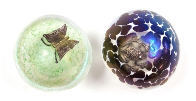 Two iridescent glass mushroom paperweights, possibly by John Ditchfield, one green decorated with an applied silver coloured butterfly, the other mottled purple decorated with an applied silver coloured frog, each 5.5cm high. - 2