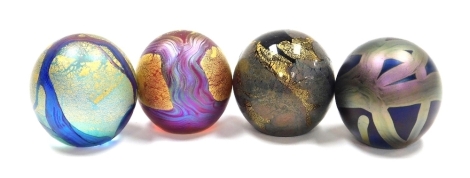 Four Isle of Wight glass orb paperweights, comprising a pair of purple paperweights with trailing decoration, gilt heightened, and two further paperweights, each with paper labels, 4.5cm high, boxed.