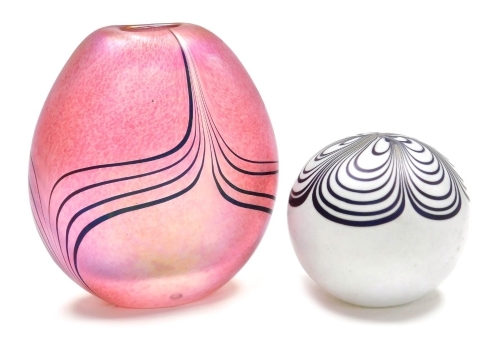 Two pieces of Glasform glass, comprising a paperweight with purple petal decoration against a white ground, 6.5cm high, and an iridescent pink vase of compressed form with trailing decoration, 11cm high, each signed Glasform to base.