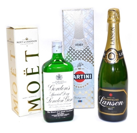 A group of alcohol, comprising a bottle of Gordons Dry Gin, 75cl, a bottle of Martini Vintage 2016 prosecco, 750ml, Lanson Black Label Brut champagne, 75cl, and Moet & Chandon champagne, 375ml.