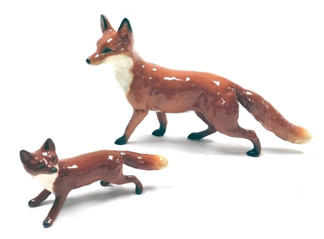 A Beswick pottery figure modelled as a standing fox, printed marks, 21cm wide, together with a further Beswick pottery box, 10cm wide.