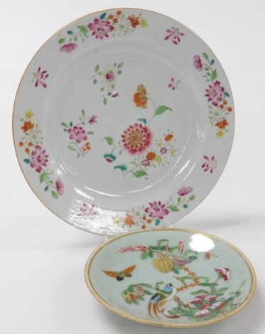 A late 18thC Chinese porcelain famille rose plate, decorated centrally and to the border with various flowers, 23cm diameter, together with a celadon dish, (2).