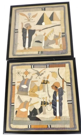 A pair of Middle Eastern embroidered pictures, each depicting camels and handlers, 49.5cm x 50cm.