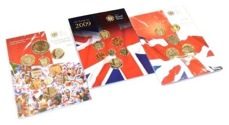 Three Royal Mint commemorative coins of the year sets, for 2009, 2011, and 2012.