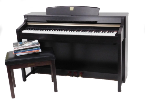 A Yamaha Clavinova, model number CLP-370, 141cm wide, together with a Yamaha piano stool, and a quantity of sheet music.