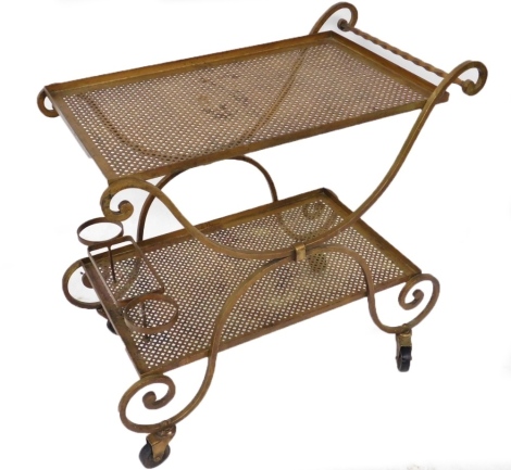 A mid 20thC gilt metal two tier drinks trolley, each tier with pierced decoration, on castors, 74cm high, 75cm wide.