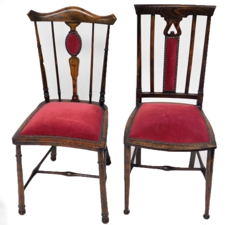 Two associated Edwaridan bedroom chairs, each with a red velvet overstuffed seat.