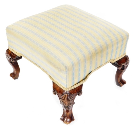 A George II style mahogany stool, with a striped overstuffed seat, raised on shell capped cabriole legs and webbed feet, 63cm wide.