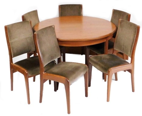 A mid century G Plan teak extending dining table, the circular top raised on cylindrical tapering legs, 74cm high, 130cm diameter, with additional leaf measuring 46cm wide, together with a set of six G Plan dining chairs. The upholstery in this lot does n