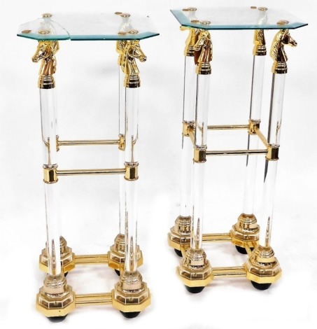 A pair of Continental side tables, each with a glass top supported by horse's heads, on cylindrical columns, 90cm high, 38cm wide, 38cm deep. (AF)