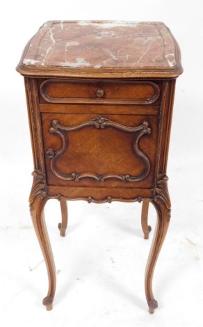 A French kingwood pot cupboard, with a shaped marble top above a frieze drawer and a carved door, raised on leaf carved cabriole legs, 86cm high, 38cm wide, 38cm deep.