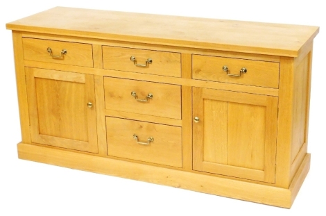 A modern oak sideboard, the rectangular top above three central drawers, flanked by two further doors above two panelled cupboards, on a plinth base, 86cm high, 170cm wide, 55cm deep. Provenance: ex lot 511 from the 2019 estate sale at Holland House, H