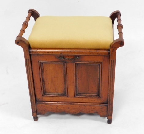 A Victorian oak piano stool, with overstuffed seat above a panelled fall, enclosing three sections for sheet music, on turned legs, 56cm high.