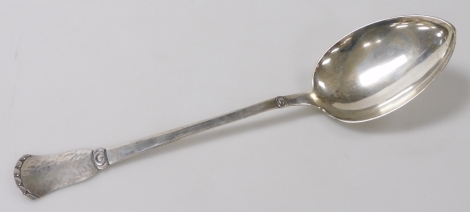 A Christian Heise Danish silver basting spoon, the handle decorated with a hammered silver section, scroll and semi circles, 4.73oz, 36cm long.