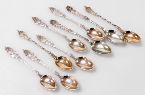 Nine Danish silver coffee spoons, comprising a set of five Simon Groth spoons, each with an intricately decorated handle of roundels, scrolls, line and dot decoration, together with a pair of Meyer spoons with twisted stem and floral swag finial, and a fu