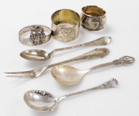 A group of Danish silver, comprising three silver tea and jam spoons, one commemorating the city of Roskilde, together with a silver pickle fork and three napkin rings, 3.93oz.