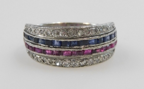 A diamond, ruby, and sapphire half hoop eternity ring, set with a band of baguette cut rubies, and sapphires, flanked by two rows of brilliant cut diamonds, set in white metal, indistinctly stamped, size M/N, 6.7g.