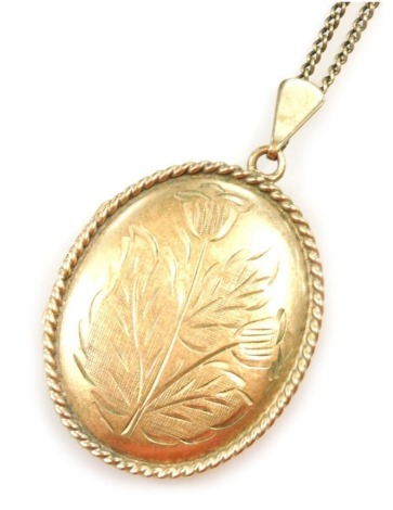 A 9ct gold oval double photo locket, floral engraved, on a curb link neck chain stamped 9ct, 14.8g.