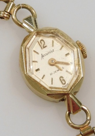 An Accurist lady's 9ct gold cased wristwatch, octagonal dial bearing Arabic numerals at twelve and six, on a 9ct gold bracelet strap, with safety chain as fitted, 11.8g all in.