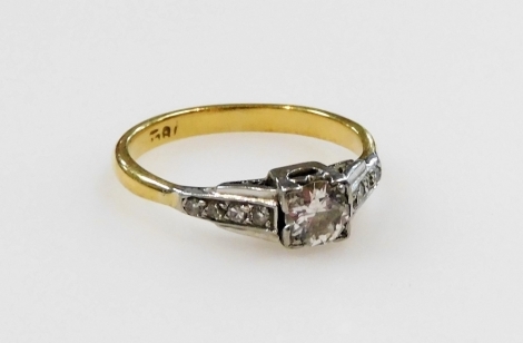 An Art Deco diamond ring, set with a brilliant cut diamond in a square mount, with shoulders each set with diamond chips, in yellow metal, stamped 18ct, approx 0.5ct, size L, 2.5g.