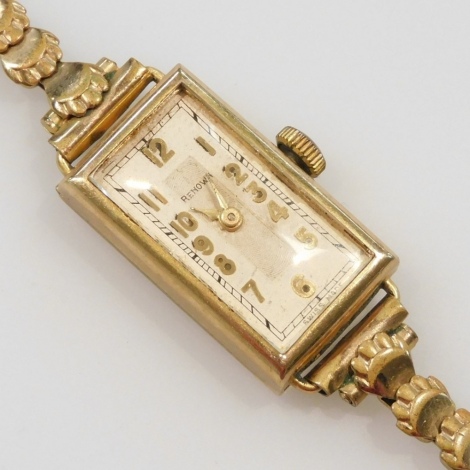 A mid century Renown 9ct gold cased lady's wristwatch, rectangular dial bearing Arabic numerals, on a plated strap.