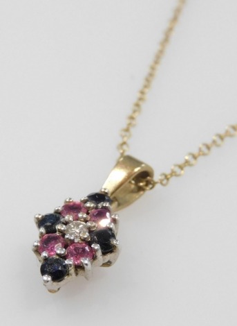 A 9ct gold diamond, ruby and sapphire pendant, in a diamond shaped design, on a belcher link neck chain, stamped 9ct, 2.5g.