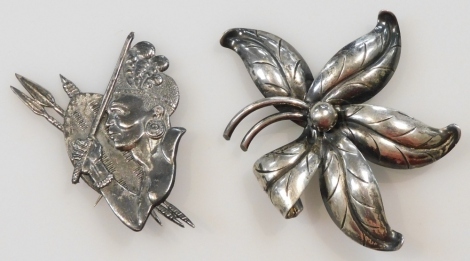 A Danish silver brooch, by Hermann Siersbol of Kastrup, of floral form, together with a Candida silver brooch, cast with a Zulu tribesman, spears and shield, 22.7g.