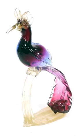 A Murano glass style sculpture of a bird of paradise, the body and tail in graduated pinks and purples, with gold coloured highlights, 31cm high.