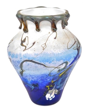 A 20thC Studio glass vase of baluster form, with an iridescent green glass drip rim, the body decorated with multicoloured flashes of colour against a graduated blue ground, indistinctly signed to underside, 19.5cm high.