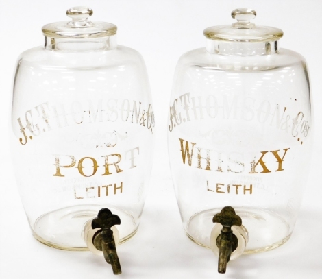 A pair of Victorian J.G.Thompson and Co of Leith glass whisky and port barrels, each of barrel form, with white and gold lettering, with lids and steel taps, 30cm high.