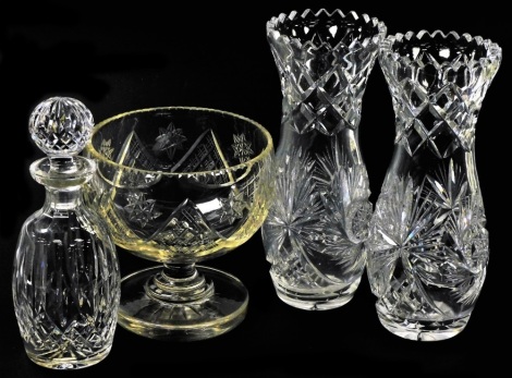 A group of cut glassware, comprising a pair of vases of waisted form, 30cm high, decanter and stopper, 27cm high, and a pedestal bowl, 20cm high.