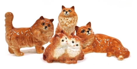 Four Beswick pottery figures modelled as ginger cats, and kittens, in varying positions, seated and standing, etc., the largest 14cm high.