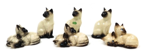 A group of Beswick pottery figures, modelled as Siamese cats, three in seated position, and a further three figures comprising pairs of cats. (a quantity)