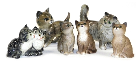 A group of Beswick pottery figures modelled as cats, in various poses, seated, standing, etc. (a quantity)