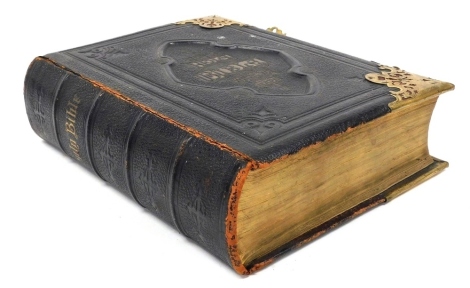 A 19thC leather bound Holy Bible, with commentaries of Scott and Henry, edited by Reverend John Eadie, published by Peter Black Manchester, with brass clasps and mounts.