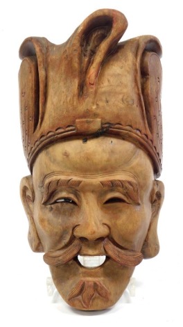 An Oriental hardwood mask, in the form of a gentleman, 30cm high.