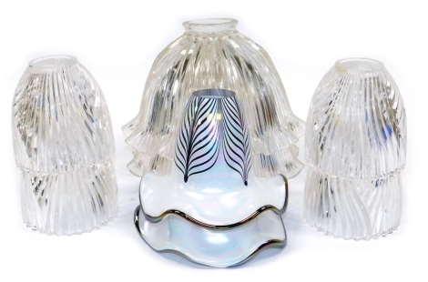 A group of glass light shades, comprising a pair of large clear glass shades, of ribbed form, 28cm diameter, a set of four clear glass shades, and a pair of white opalescent glass shades with purple leaf pattern decoration and purple edging, 17cm wide.