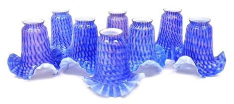 A group of moulded glass light shades, each in a pink and blue repeating pattern. (1 tray)