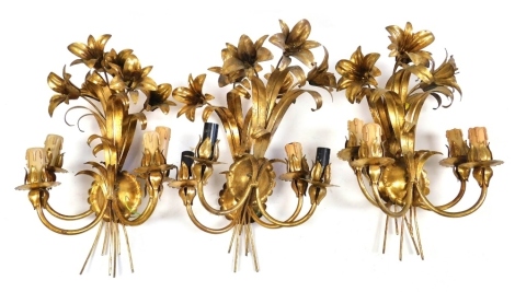 A set of six 20thC gilt metal two branch wall lights, each surmounted by three flowers, leaves, etc., 45cm high.