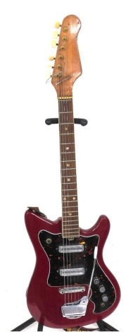 An electric guitar, unmarked, with red body with simulated tortoiseshell decoration.