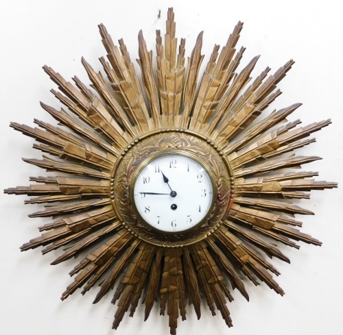 An early 20thC French starburst wall clock, the circular white enamel dial bearing Arabic numerals, thirty hour movement, 64cm diameter.