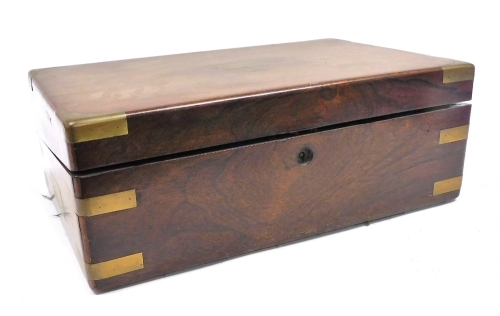 A Victorian walnut and brass bound writing slope, the hinged lid opening to reveal a slope and fitted interior, 41cm wide, 25cm deep.