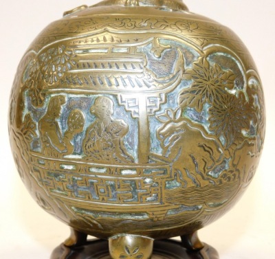 A Qing Dynasty Chinese bronze censer and cover, embossed with reserves of figures in a garden, the lid with a dragon finial, raised on three cabriole legs, with a hardwood stand, 23cm high. - 2