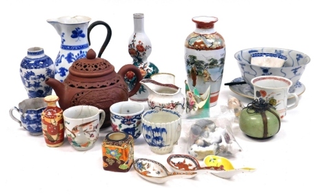 A group of Asian and European ceramics, including a Chinese red ware teapot, Kakiemon porcelain vase, blue and white baluster vase, plates, jugs, and miniature figures, etc. (a quantity)