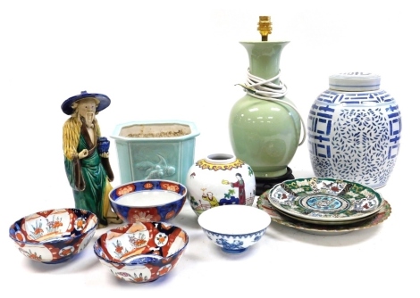 A group of Chinese ceramics, including a Sancai figure of a pheasant, Cantonese famille rose porcelain plates, Imari bowls, blue and white ginger jar and cover, and a celedon table lamp. (a quantity)