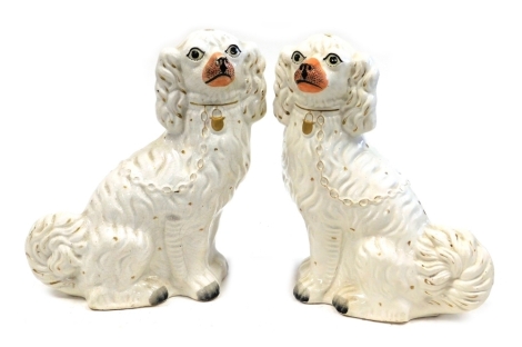 A pair of late 19thC Staffordshire spaniels, with gilt markings, 32cm high.