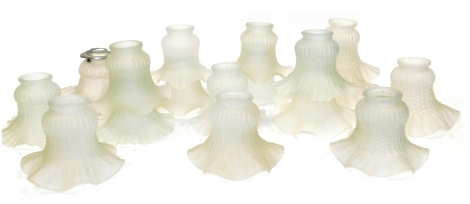 Seventeen frosted glass lamp shades, variously moulded, each 13cm wide.