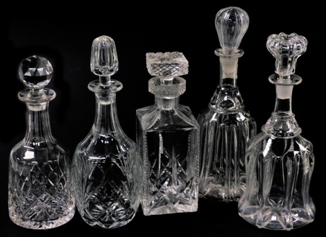 Five cut glass decanters and stoppers, including two mallet shaped decanters.